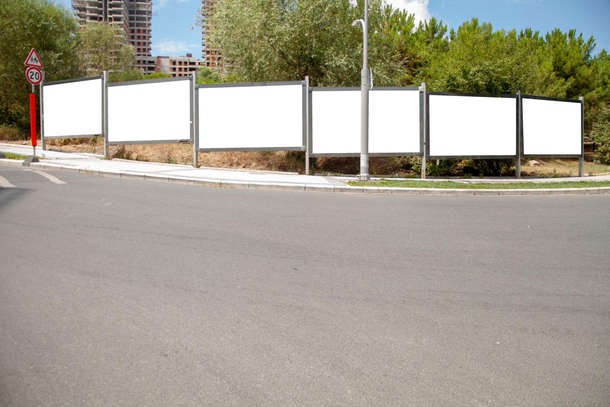 Multiple roadside JR posters creating repeated brand exposure for local businesses